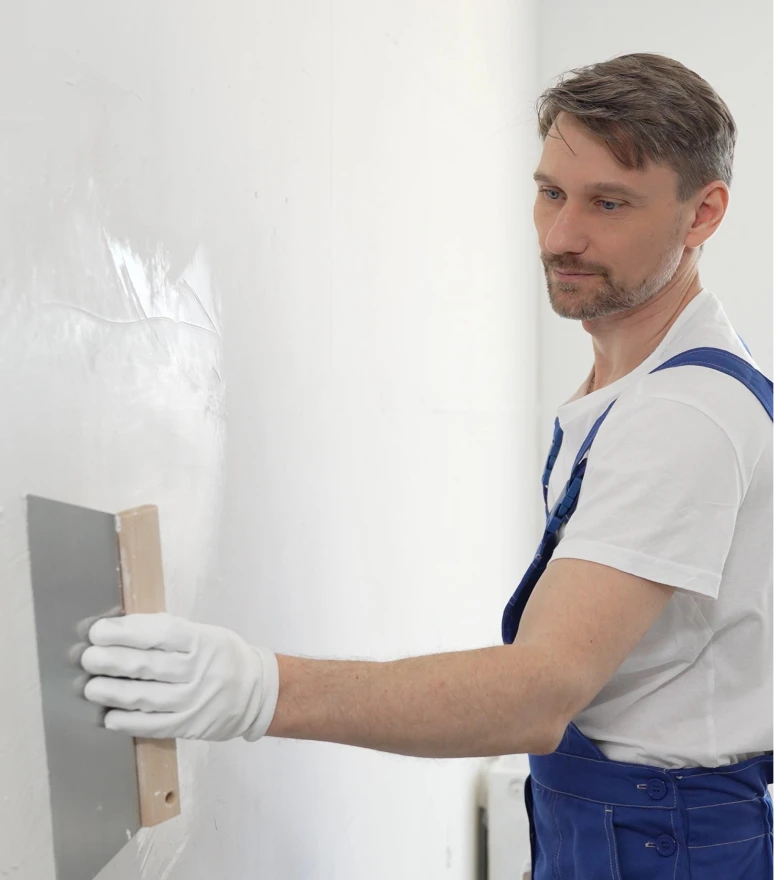 Worker smoothing wall surface