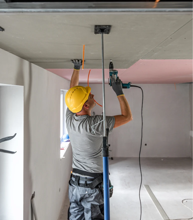 Man in hard hat fixing ceiling